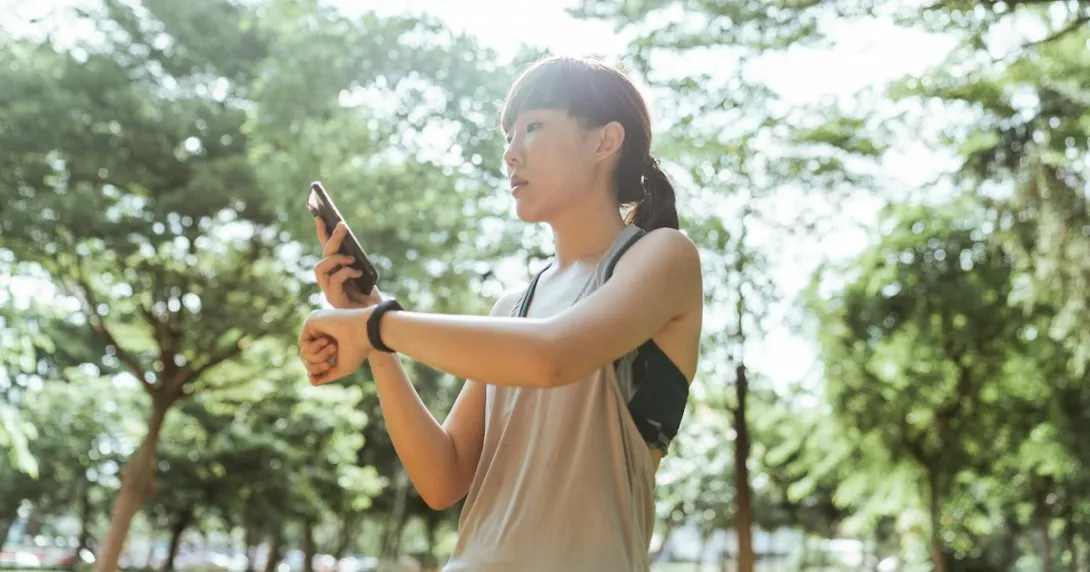 A person checking their fitness tracker data on their mobile phone