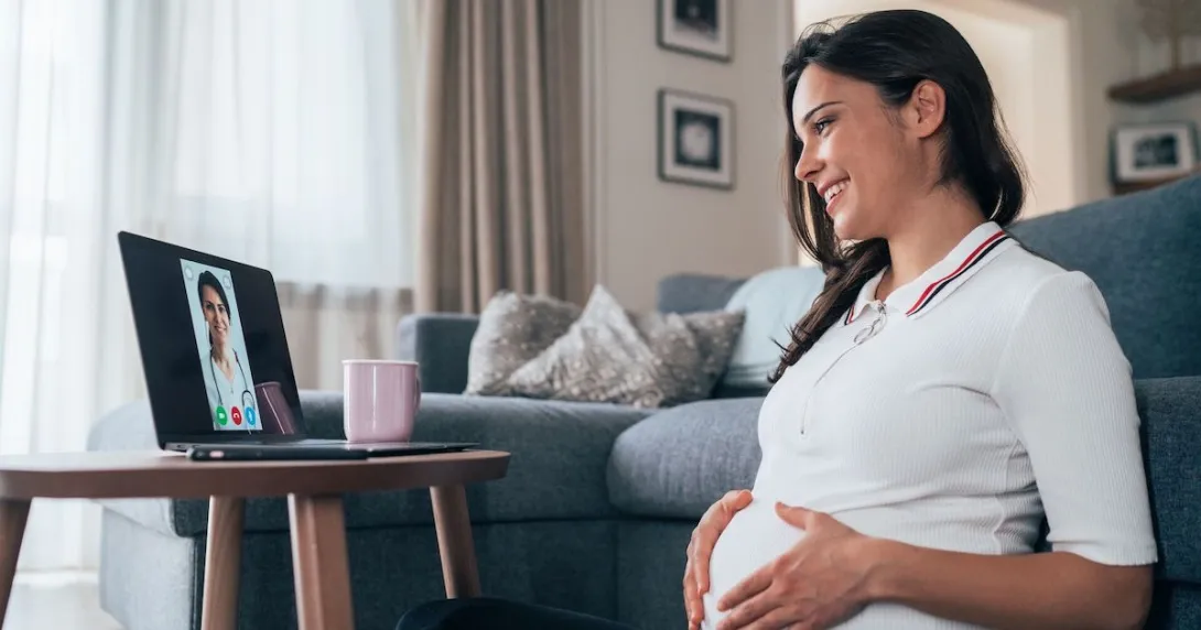 A pregnant person talks to a provider via telehealth