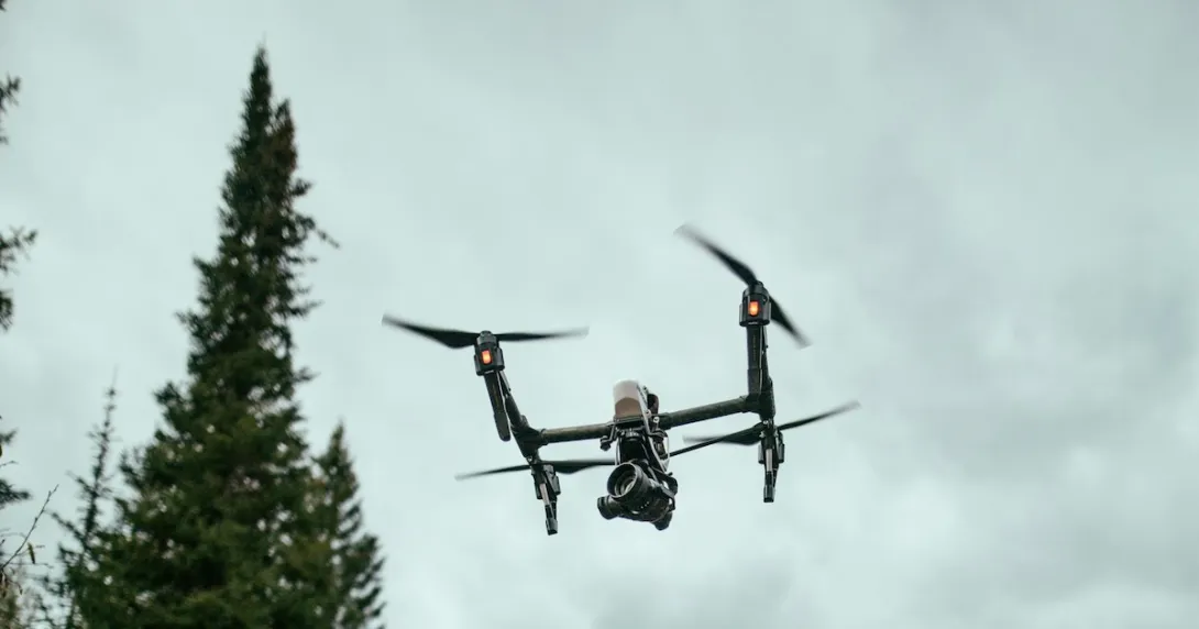 A drone flying over a forest area