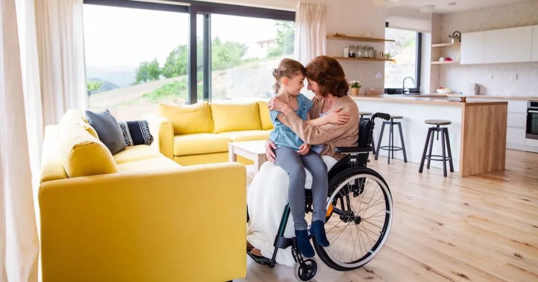 A person in a wheelchair holding a child